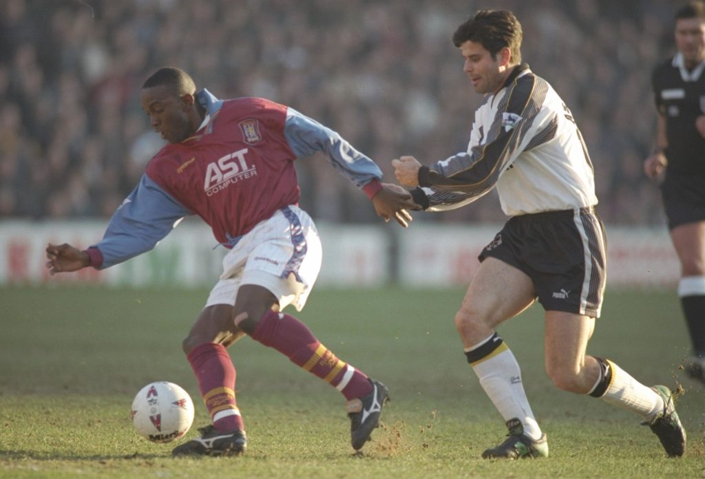 Dwight Yorke of Aston Villa (left) holds of Aljosa Asanovic of Derby